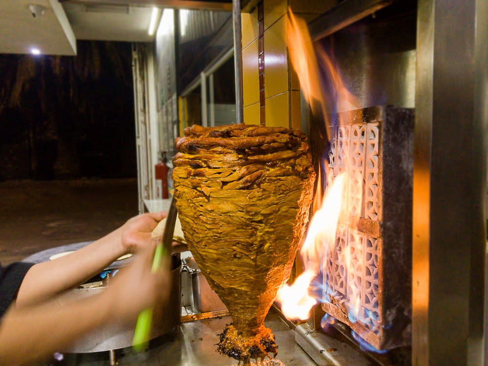 Al Pastor Pork cooking on Shawarma Grill