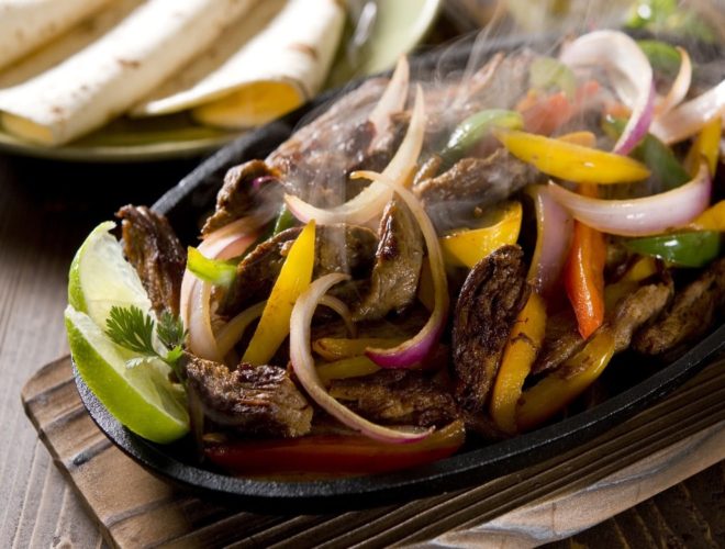 sizzling fajitas on platter