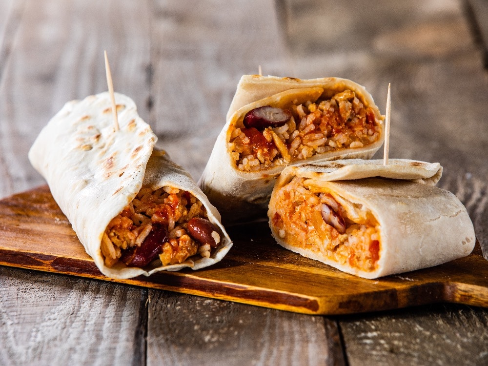 picture of burritos on a wooden board